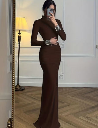 Person wearing a brown long-sleeve dress taking a mirror selfie.
