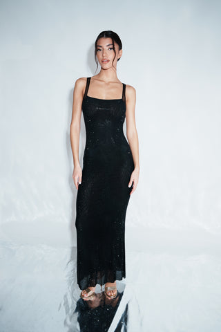 Woman wearing a black dress against a white background