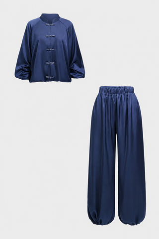 A two-piece kids' athletic set featuring a short-sleeve blue top and matching dark blue shorts, shown against a plain white background.