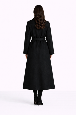 Woman wearing a black coat on a white background