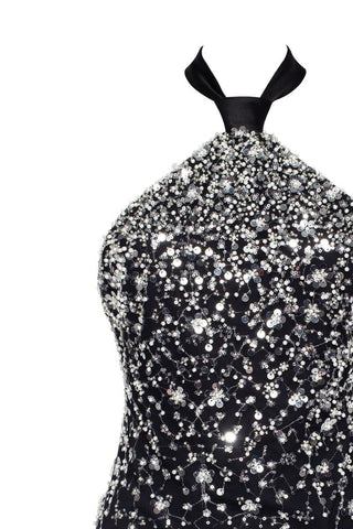 Black evening gown with silver sequins on a white background
