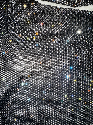 Close-up of a black fabric with embedded rhinestones