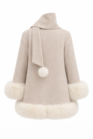 Beige cape with white fur trim on a white background