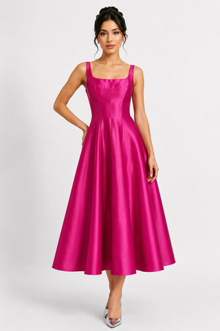 Elegant hot pink satin midi dress with vintage-inspired square neckline and full A-line skirt, modeled by a dark-haired woman in a clean studio setting. Feminine old-money style formal dress perfect for prom, cocktail parties, wedding guest outfits, gala events, bridesmaid looks, and luxury eveningwear.