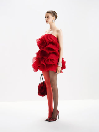 Woman wearing a red floral dress on a white background