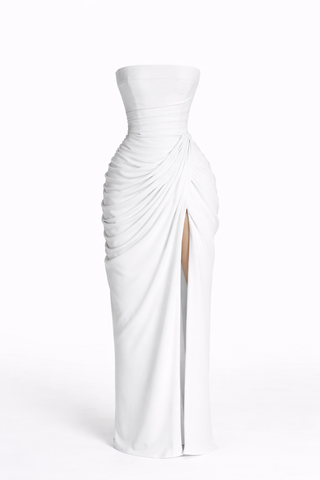 White strapless gown with a slit on a white background
