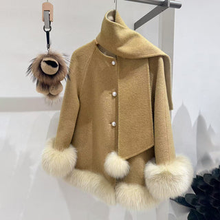 Beige coat with fur accents on a hanger against a white background