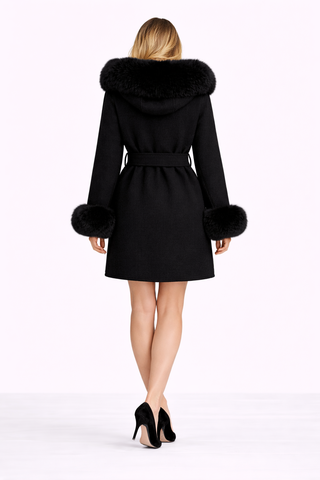Black coat with fur trim worn by a model on a white background
