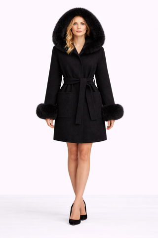 Woman wearing a black coat with fur trim on a white background