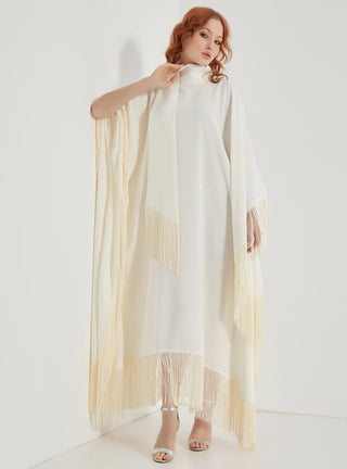 Woman holding a long, light-colored scarf against a white background