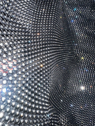 Close-up of a textured black surface with reflective material