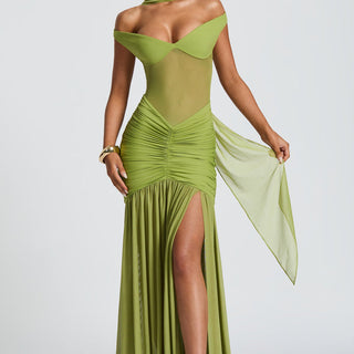 Green evening gown with a high slit on a white background