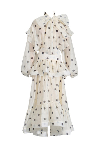 White dress with black polka dots on a white background
