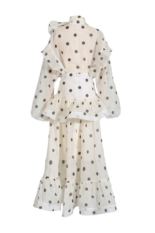 White dress with black polka dots on a white background