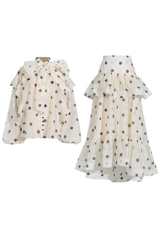 Two polka dot dresses on a white background