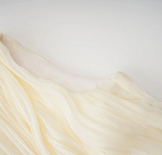 Sheer fabric with a gradient of yellow to white on a light gray background