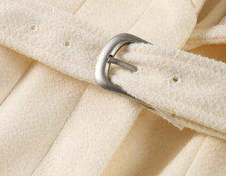 Close-up of a beige fabric with a metal buckle