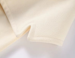 Close-up of beige fabric on a light gray background