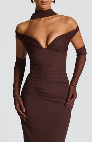 Brown evening gown with long gloves on a plain background