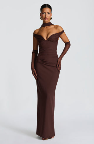 Woman wearing a brown off-shoulder evening gown on a white background