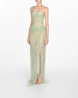 Model wearing a soft green tulle lace dress with asymmetrical one-shoulder strap, fitted bodice, and draped skirt, perfect for summer weddings and special occasions. Bridesmaids Sage green dress 