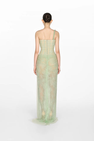 Model wearing a soft green tulle lace dress with asymmetrical one-shoulder strap, fitted bodice, and draped skirt, perfect for summer weddings and special occasions. Bridesmaids Sage green dress 