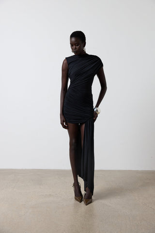 Woman wearing a black dress with a plain background