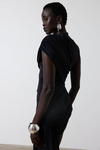 Woman wearing a black dress with a plain background