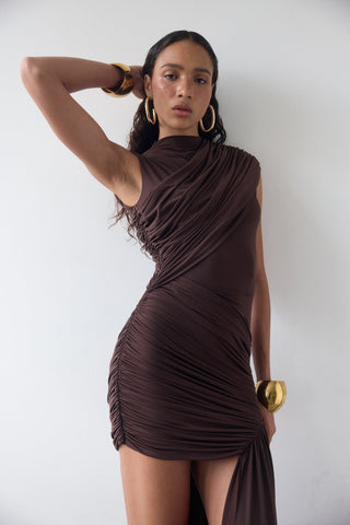 Woman wearing a brown dress against a white background