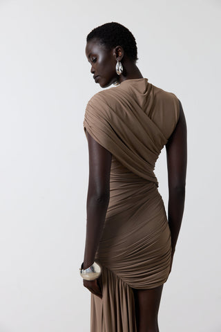 Woman wearing a brown dress against a white background