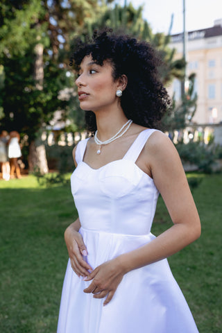 Elegant Alaia bridal dress with a vintage modern chic design, featuring a flattering V-neckline, sleeveless cut, adjustable back straps, and a full skirt with a subtle flare. Perfect minimalistic wedding gown for the contemporary bride seeking timeless elegance.Modern clean minimal dress white A line Spaghetti Straps, Corset Bustier - Cielie 