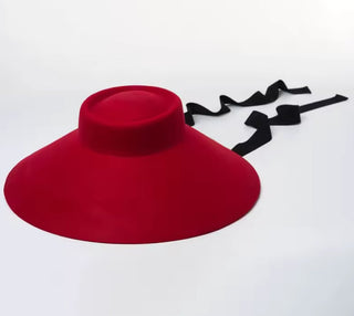 Red hat with a black ribbon on a white background