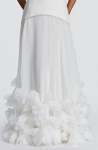 White pleated skirt with ruffled bottom on a white background