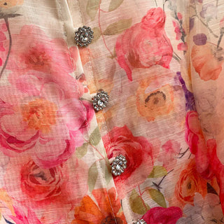 Romantic floral mini dress featuring a colorful pink and coral floral print, sheer long sleeves, high neckline, decorative front buttons, removable waist tie belt, fit and flare silhouette, and fully lined design, perfect for wedding guests, baby showers, garden parties, bridal showers, and elegant spring and summer occasions.zimmermann style inspired dupe