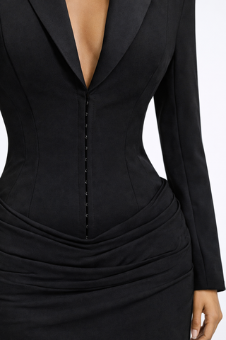 Black dress with a plunging neckline and long sleeves on a white background